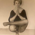 Ailsa Gartenstein in a seated balance with hands joined at the chest, sepia studio portrait